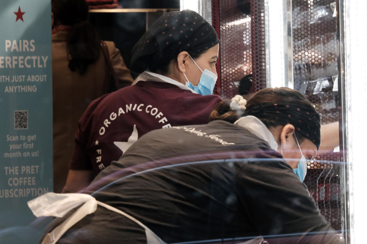 NEW YORK, NEW YORK - DECEMBER 13: Workers at a restaurant  wear masks in lower Manhattan on the day that a mask mandate went into effect in New York on December 13, 2021 in New York City. As parts of New York are seeing a surge in Covid cases, New York Governor Kathy Hochul has enacted a new mask mandate with fines up to $1,000 per violation. (Photo by Spencer Platt/Getty Images)