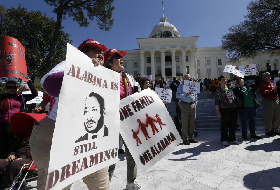 FILE - Demonstrators Gwendolyn Perrette, left, of Tuscaloosa, Ala., and Miriam Billanuava, of Birmingham, Ala., chant with others outside the Capitol in Montgomery, Ala., March 8, 2013. The group re-enacting the Selma-to-Montgomery voting rights march completed the journey Friday. A U.S. Supreme Court decision a decade ago that tossed out the heart of the Voting Rights Act continues to reverberate across the country. Republican-led states continue to pass voting restrictions that, in several cases, would have been subject to federal review had the court left the provision intact.(AP Photo/Dave Martin)