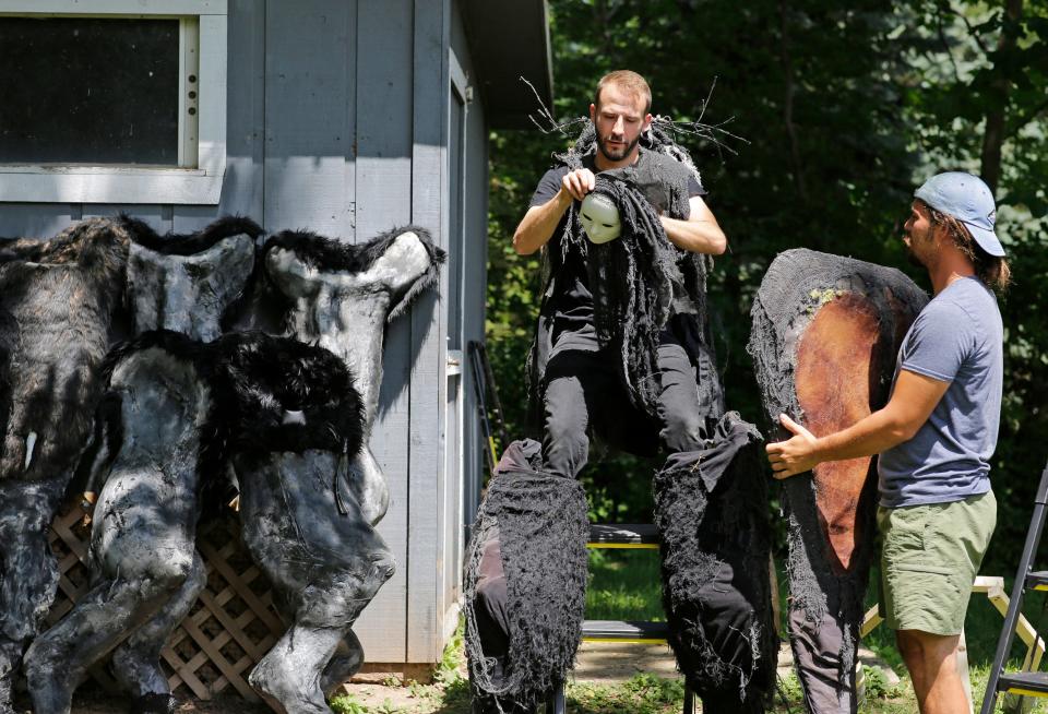 Creator Brandon Johnson is assisted by Vincent Landowski as he dons a Spiritwalker costume for a photo shoot Wednesday, July 20, 2022, in Appleton, Wis.