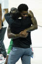 North Texas's Javion Hamlet hugs head coach Grant McCasland celebrates after North Texas defeated Purdue, 78-69, in overtime of a first-round game in the NCAA men's college basketball tournament at Lucas Oil Stadium, Friday, March 19, 2021, in Indianapolis. (AP Photo/Darron Cummings)