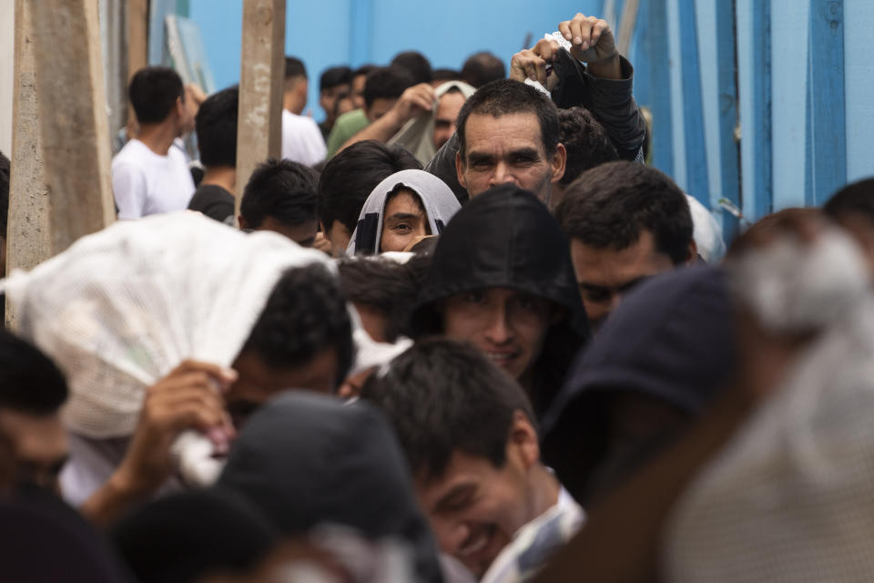 Guatemalan men who were deported from the United States, leave the Air Force Base after arriving in Guatemala City, Tuesday, July 16, 2019. Nearly 200 Guatemalan migrants have been deported on Tuesday, the day the Trump administration planned to launch a drastic policy change designed to end asylum protections for most migrants who travel through another country to reach the United States. (AP Photo/Moises Castillo)