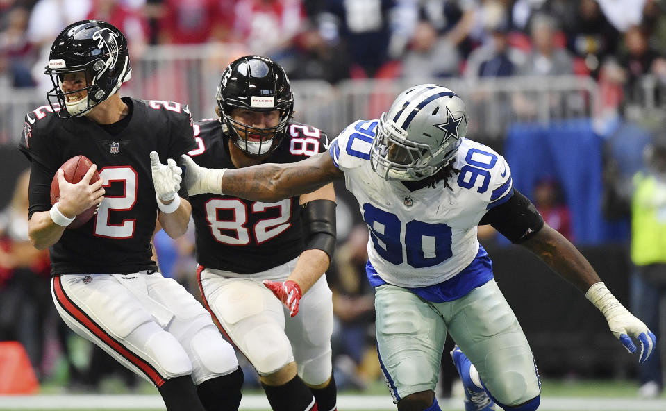 Dallas Cowboys defensive end Demarcus Lawrence (90) pressures Atlanta Falcons quarterback Matt Ryan (2) during the second half of an NFL football game, Sunday, Nov. 18, 2018, in Atlanta. (AP Photo/Danny Karnik)