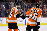 Philadelphia Flyers' Tanner Laczynski, left, celebrates his goal with Joel Farabee (86) during the first period of an NHL hockey game, Monday, Dec. 5, 2022, in Philadelphia. (AP Photo/Derik Hamilton)