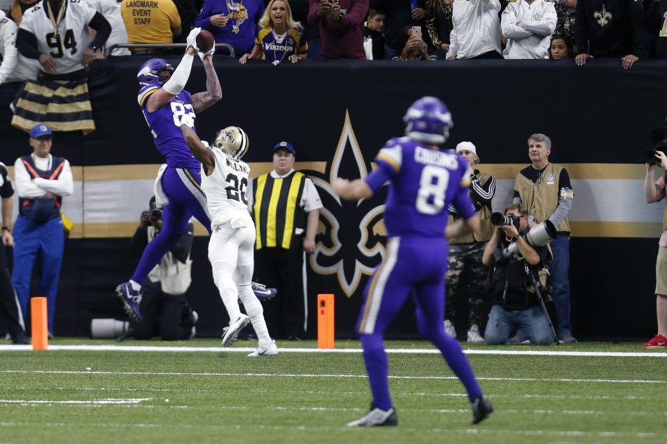 Minnesota Vikings tight end Kyle Rudolph (82) pulls in the game winning touchdown pass over New Orleans Saints cornerback P.J. Williams (28) during overtime of an NFL wild-card playoff football game, Sunday, Jan. 5, 2020, in New Orleans. The Vikings won 26-20. (AP Photo/Butch Dill)