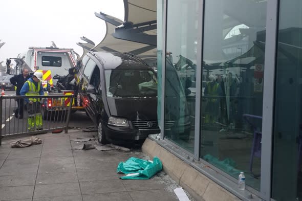 Taxi crashes into Heathrow terminal after driver suffers heart attack