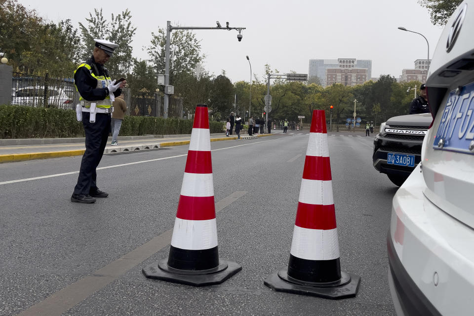 A police blocks the roads near the Babaoshan Revolutionary Cemetery in Beijing Thursday, Nov. 2, 2023. Hundreds, possibly thousands, of people gathered near a state funeral home Thursday as former Premier Li Keqiang was being put to rest. (AP Photo/Andy Wong)