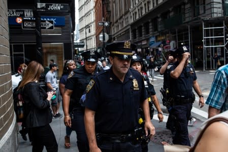 New York City Police Department officers are seen near the Fulton Street subway station as police said they were investigating two suspicious packages in Manhattan