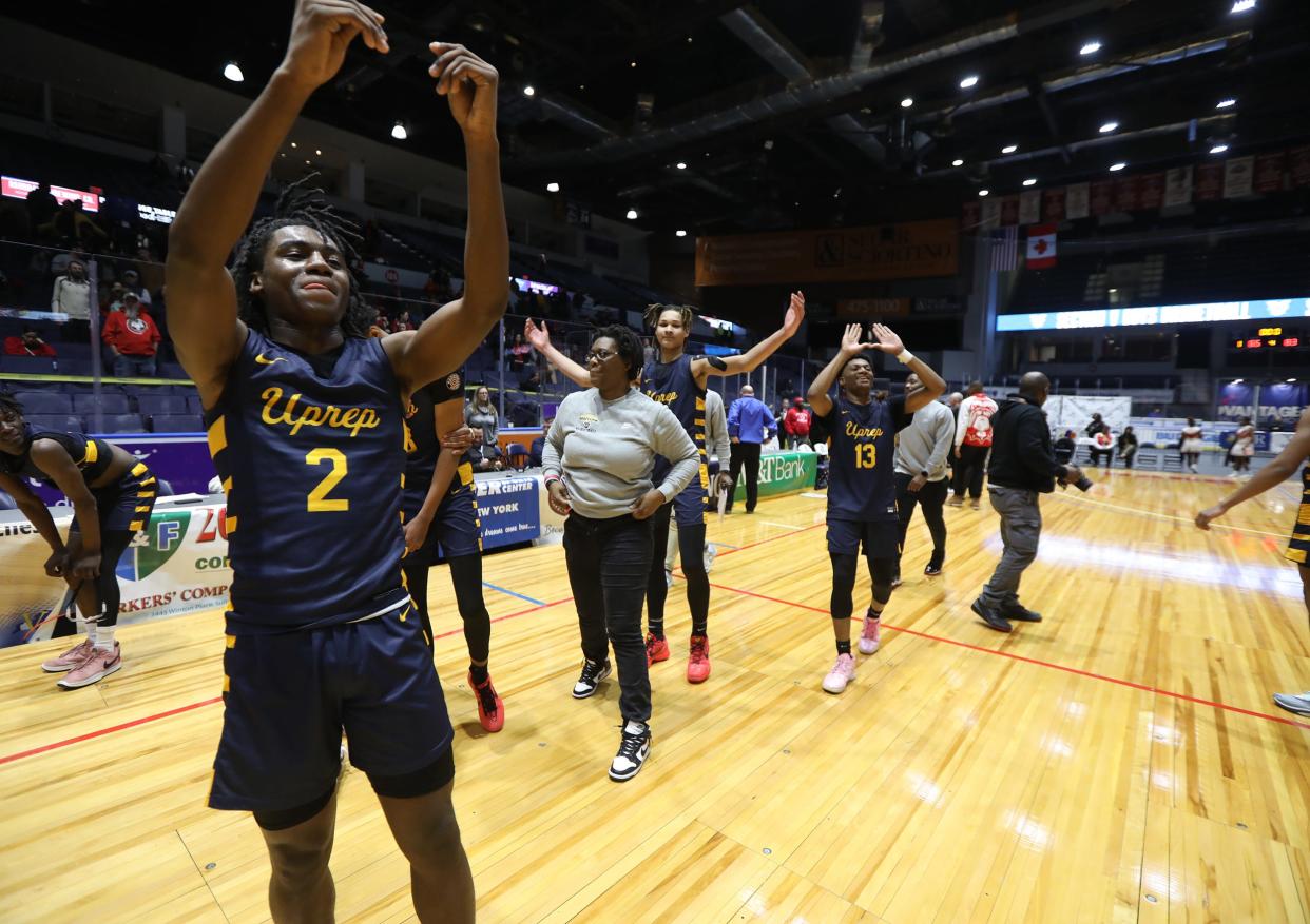 UPrep's Gregory Bodine and Jermelle Cotton make a U sign with their arms towards their friends and fans in the stands after winning their Class AAA Section V Championship.