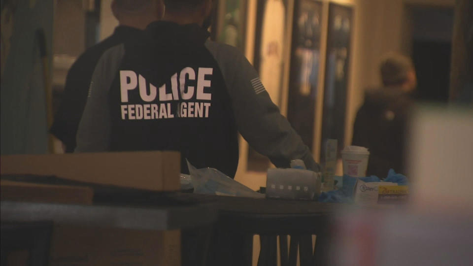 A federal agent inside a Woburn restaurant.  / Credit: CBS Boston