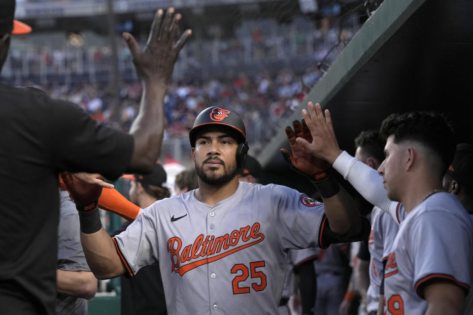 Baltimore Orioles' Anthony Santander (25) is congratulated in the dugout after his solo home run against the Washington Nationals during the fourth inning of a baseball game at Nationals Park in Washington, Wednesday, May 8, 2024. (AP Photo/Susan Walsh)
