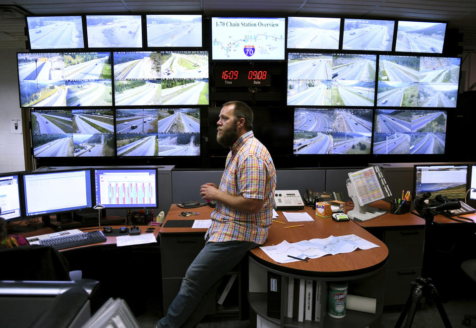 In this Sept. 8, 2017, photo, Craig Pike, monitors traffic from a Colorado Department of Transportation office at the mouth of two tunnels bored under the Continental Divide. In 2018, about 13.4 million vehicles on I-70 crossed the Continental Divide, which slices through the heart of Colorado's ski country. (AP Photo/Thomas Peipert)