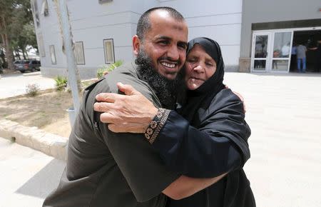 A Palestinian man hugs his mother after she returned to Gaza through the Rafah border crossing between Egypt and southern Gaza Strip May 26, 2015. REUTERS/Ibraheem Abu Mustafa