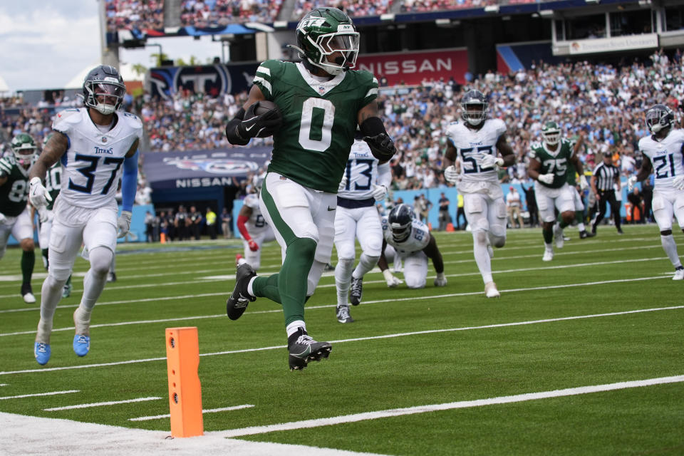 New York Jets running back Braelon Allen (0) runs the ball in for a touchdown against Tennessee Titans safety Amani Hooker (37) in the second half of an NFL football game in Nashville, Tenn., on Sunday, Sept. 15, 2024. (AP Photo/George Walker IV)