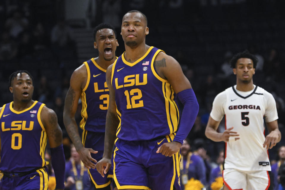 LSU forward KJ Williams (12) walks up court as forward Shawn Phillips celebrates behind him after scoring against Georgia in the final moments of an NCAA college basketball game in the first round of the Southeastern Conference tournament, Wednesday, March 8, 2023, in Nashville, Tenn. LSU won 72-67. (AP Photo/John Amis)