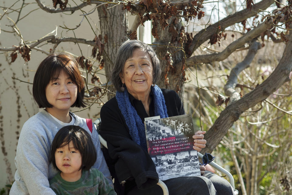 Kathy Masaoka poses with her daughter, Mayumi, and her grandson, Yuma, outside her home in Los Angeles on Sunday, Feb. 12, 2023. (AP Photo/Damian Dovarganes)