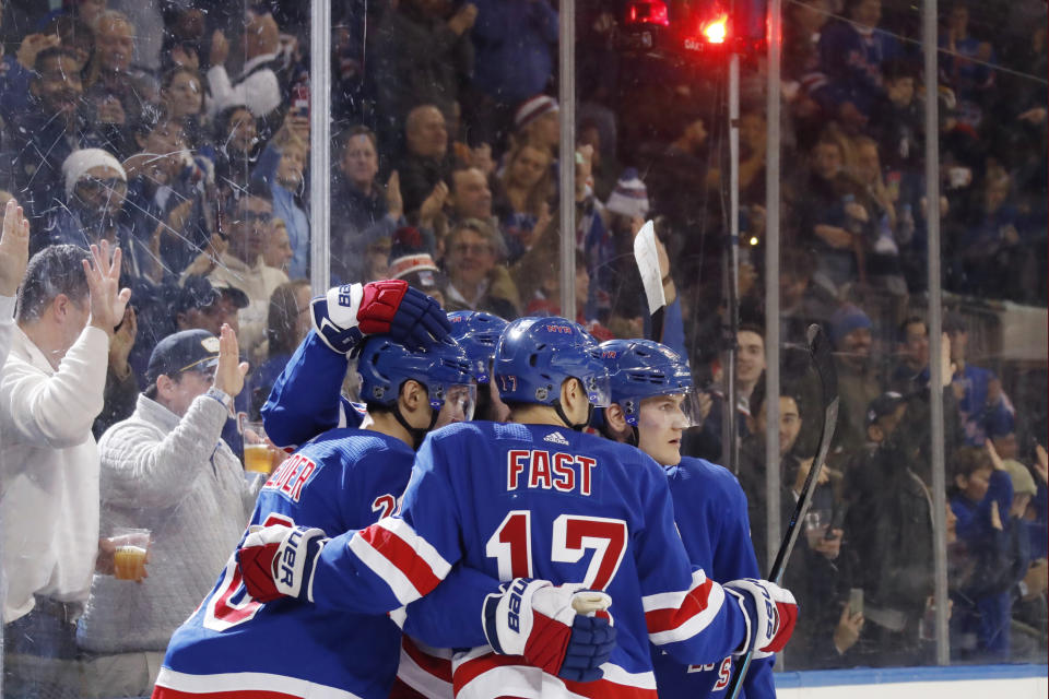 Teammates celebrate with New York Rangers left wing Chris Kreider, left, after Kreider scored a goal during the second period of an NHL hockey game against the Anaheim Ducks, Sunday, Dec. 22, 2019, in New York. It was Kreider's second goal of the game.(AP Photo/Kathy Willens)