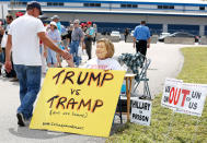 <p>Bob Kunst, a supporter of US President Donald Trump from Miami Beach, gets a high-five while waiting to attend a rally at the Orlando Melbourne International Airport on February 18, 2017. (Gregg Newton/Getty Images) </p>