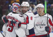 Washington Capitals goalie Charlie Lindgren, from left to right, Alex Ovechkin and Martin Fehervary celebrate after Washington defeated the Vancouver Canucks in an NHL hockey game in Vancouver, British Columbia, Saturday, March 16, 2024. (Darryl Dyck/The Canadian Press via AP)