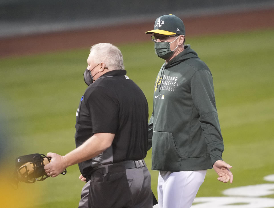 Oakland Athletics manager Bob Melvin, right, argues a call by umpire Bill Miller during the fourth inning against the Toronto Blue Jays in a baseball game in Oakland, Calif., on Monday, May 3, 2021. (AP Photo/Tony Avelar)