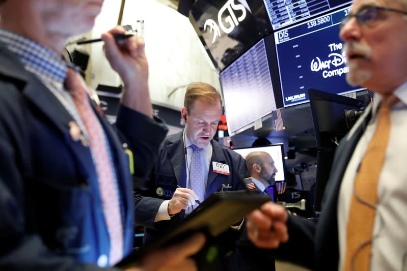 Traders work on the floor at the NYSE in New York