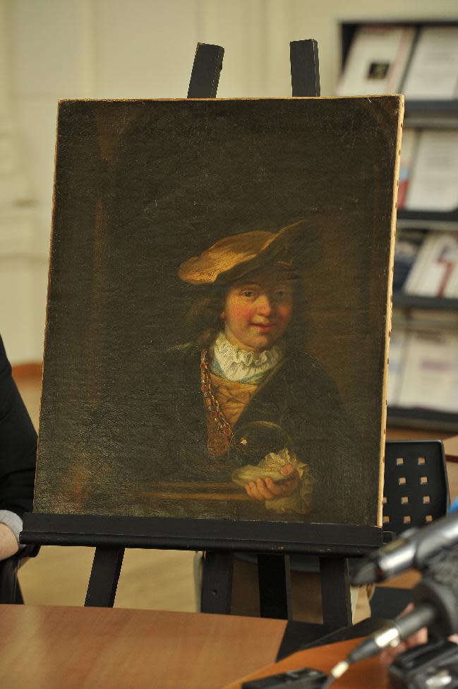 Rembrandt's painting "Child with a Soap Bubble", stolen in 1999 from the municipal museum of Draguignan in southeastern France, is presented to the press in Nice, southeastern France, Thursday, March 20, 2014. The Rembrandt painting worth millions has been recovered in Nice, and two people found in possession of the Dutch master's painting have been arrested, a source close to the investigation said on March 19, 2014.(AP Photo/str)