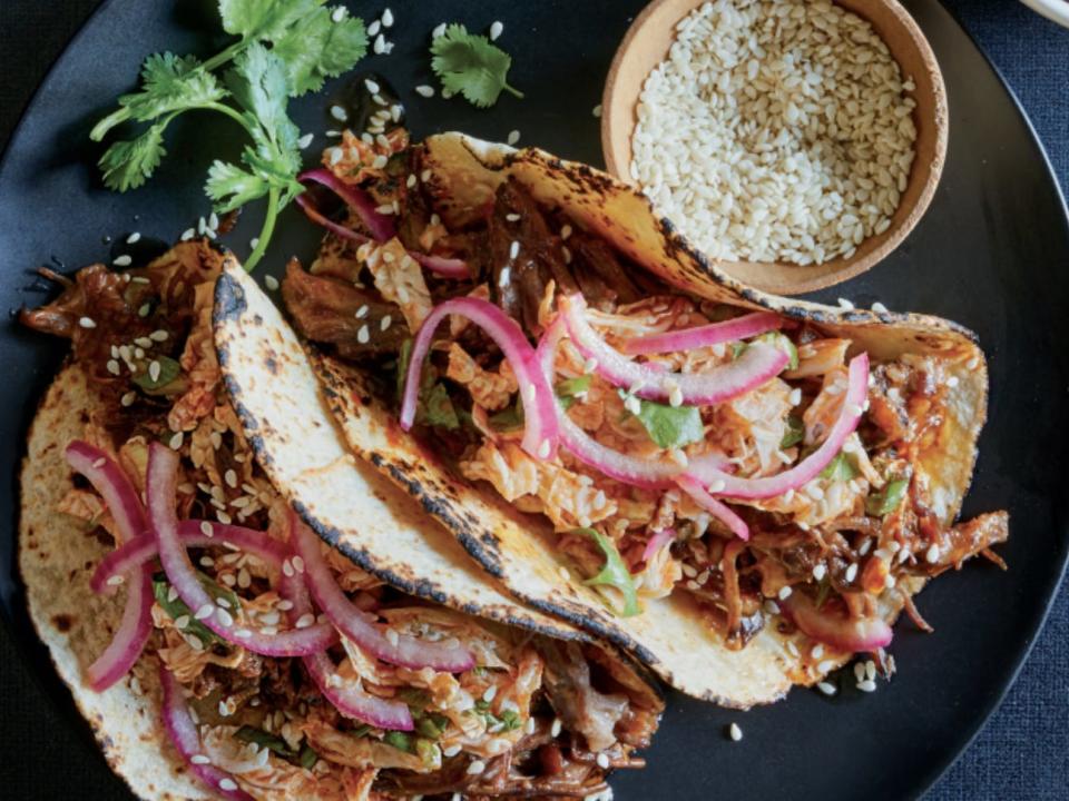 slow cooker short rib tacos with red onion on a plate