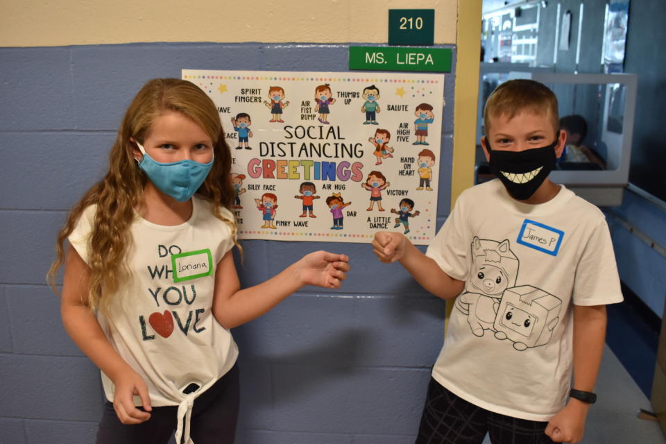 Harbor fourth graders Loriana Taormina and Jimmy Prinzevali practiced an air fist bump, one of several social distancing greetings they learned on the first day of school.(Courtesy of the Seaford Union Free School District)