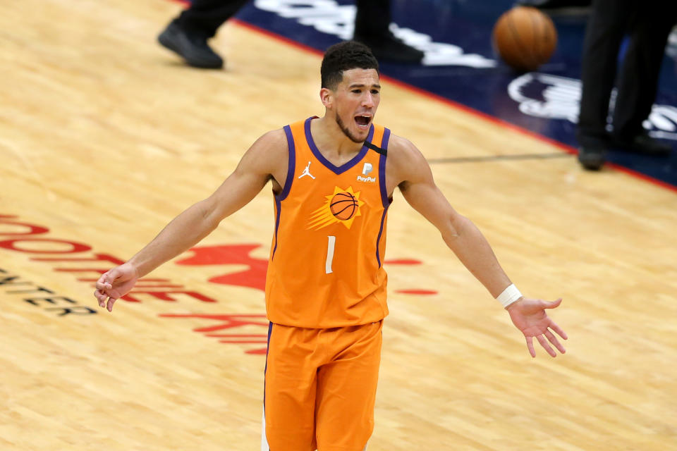 Feb 19, 2021; New Orleans, Louisiana, USA; Phoenix Suns guard Devin Booker (1) reacts after being called for a technical foul in the third quarter against the New Orleans Pelicans at the Smoothie King Center. 