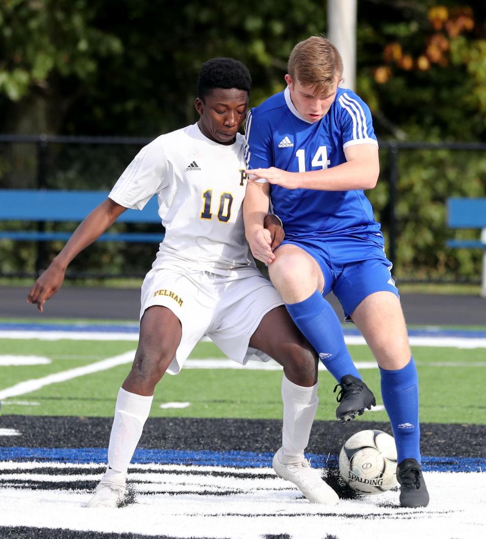 Pelham's Stephan Akichy and Pearl River's Brian Coughlin vie for the ball during a first-round soccer playoff game at Pearl River High School Oct. 19, 2018.