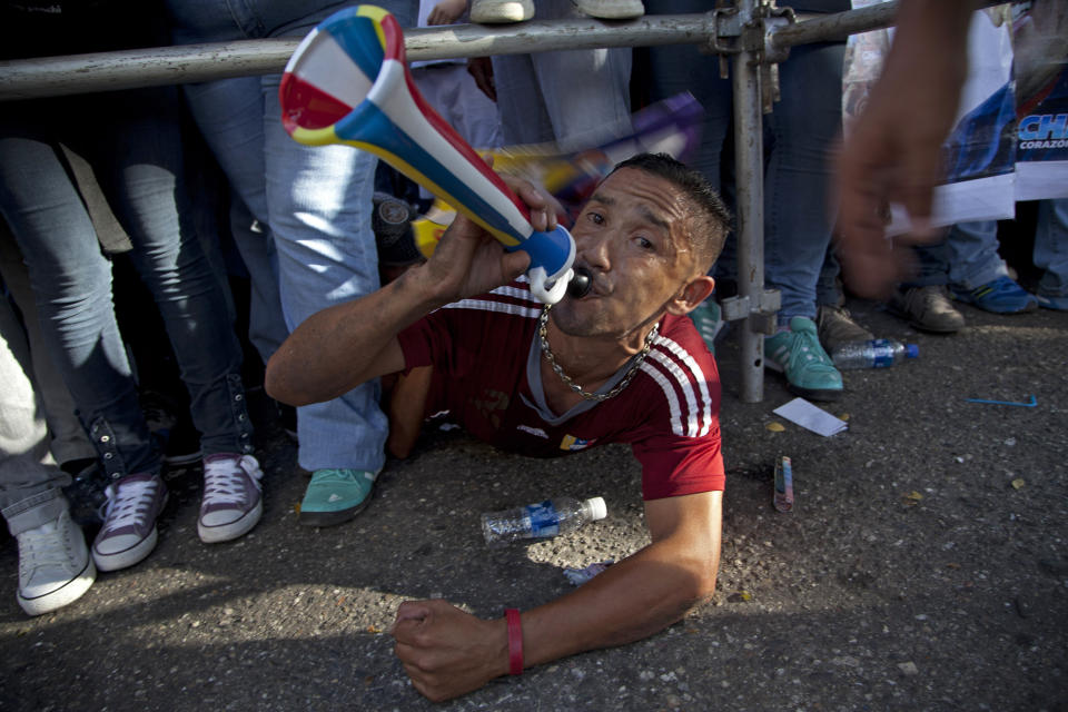 A supporter of Venezuela's President Hugo Chavez blows a horn during a campaign rally in Guarenas, Venezuela, Saturday, Sept. 29, 2012. Venezuela's presidential election is scheduled for Oct. 7. (AP Photo/Ariana Cubillos)