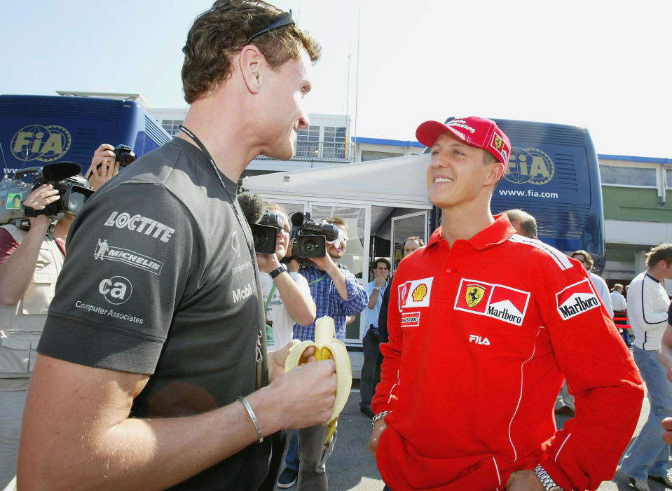 IMOLA, ITALY - APRIL 22:  Michael Schumacher of Germany and Ferrari talks to David Coulthard of Great Britain and McLaren Mercedes during the previews to the San Marino F1 Grand Prix on April 22, 2004, at the San Marino circuit in Imola, Italy. (Photo by Clive Mason/Getty Images) 