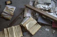 Books lie on the floor of an abandoned factory in the town of Elefsina, near Athens, Greece June 30, 2015. REUTERS/Marko Djurica