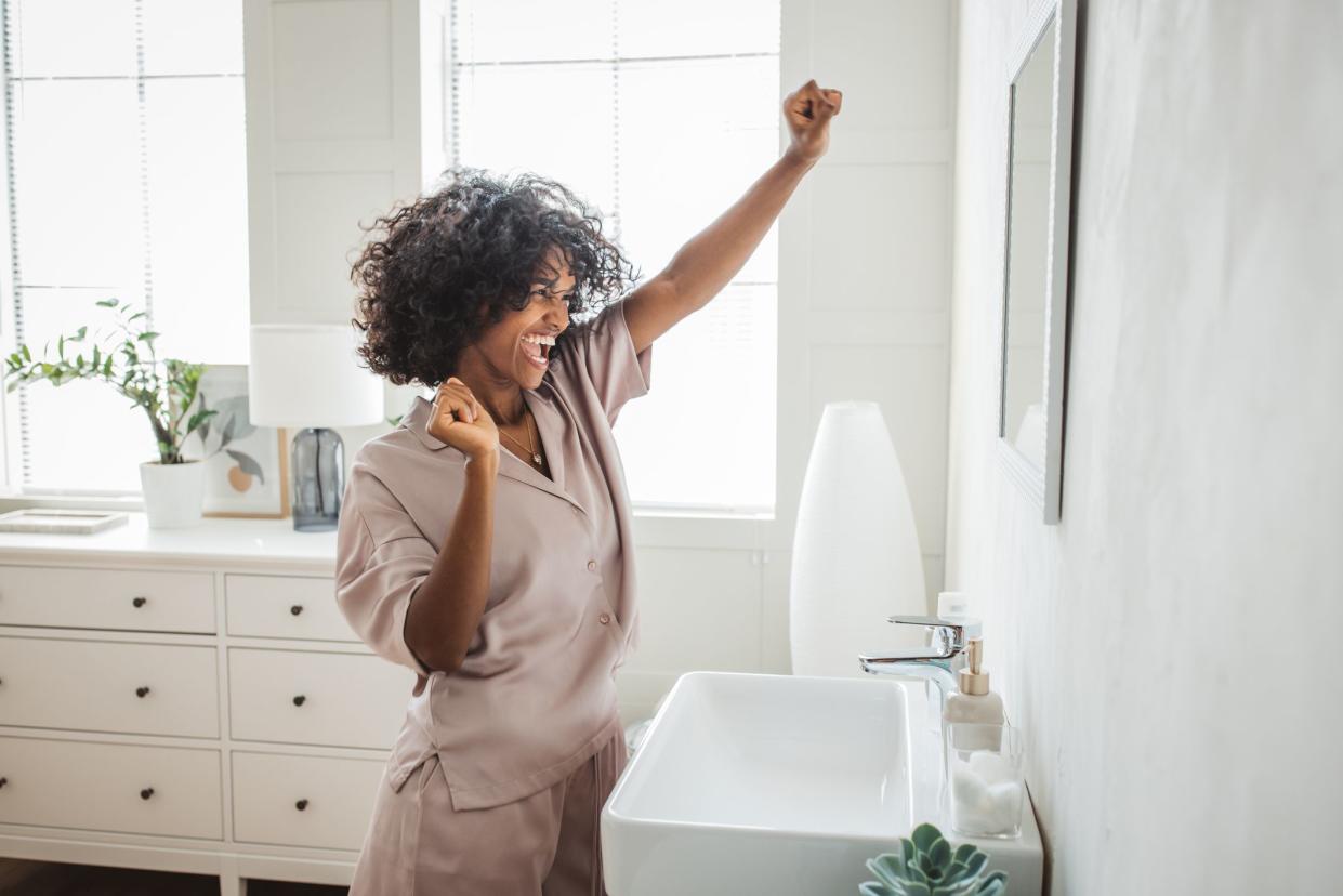 Happy relaxed millennial African girl in pajama enjoying her morning.