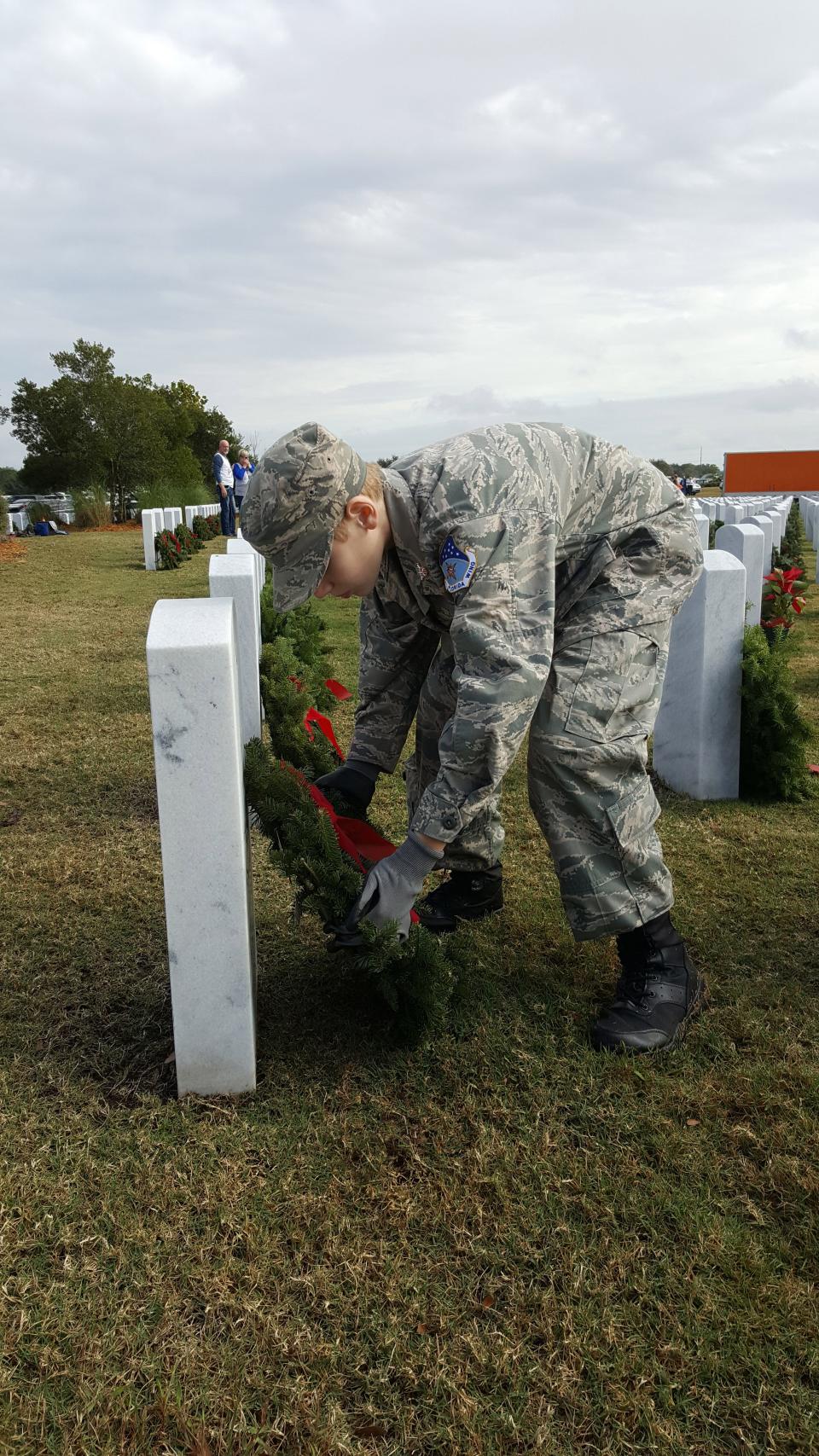 A Civil Air Patrol Cadet with SRQ Composite Squadron, Sarasota, lays a wreath at Sarasota National Cemetery during the 2018 ceremony.