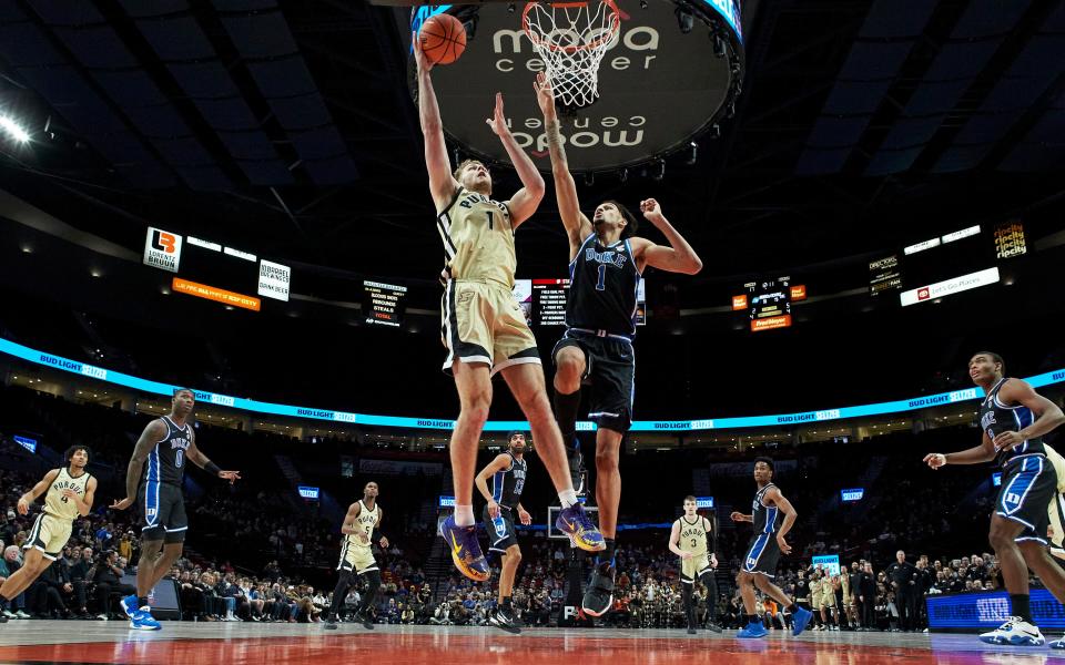 Purdue forward Caleb Furst, left, shoots over Duke center Dereck Lively II during the first half of an NCAA college basketball game in the Phil Knight Legacy Championship in Portland, Ore., Sunday, Nov. 27, 2022. (AP Photo/Craig Mitchelldyer)