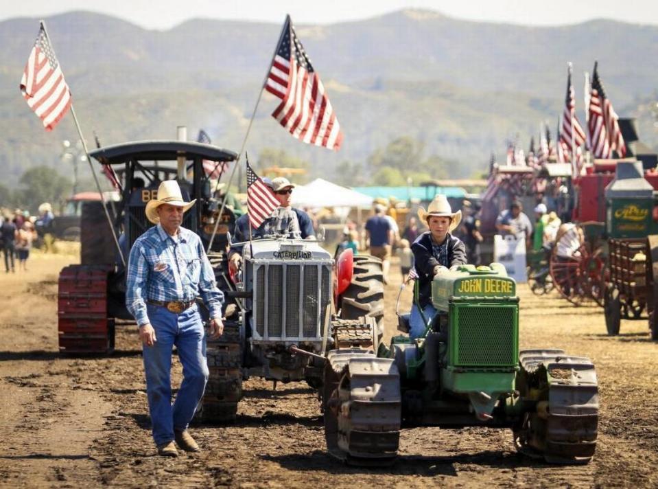 Jake Merrill, 10, of Saratoga, drives his great-great-great grandfather’s John Deere 1940 Model D tractor as his grandfather, Lupe Rodriquez walks beside him in the tractor parade during the Best of the West Antique Equipment Show in 2017. The event returns to Santa Margarita Ranch for Memorial Day weekend in 2023.