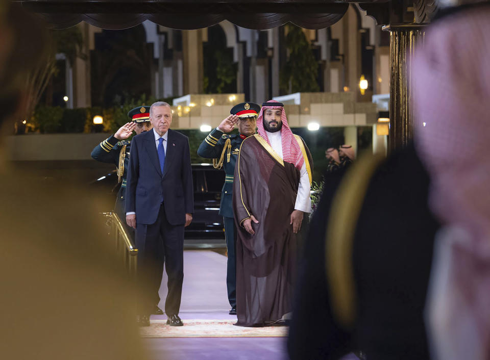 In this photo released by the state-run Saudi Press Agency, Turkish President Recep Tayyip Erdogan, left, and Saudi Crown Prince Mohammed bin Salman attend a welcome ceremony at Al Salam Palace in Jeddah, Saudi Arabia, Monday, July 17, 2023. Erdogan traveled to Saudi Arabia on Monday in a three-stop tour of Gulf states to seek trade and investment opportunities for Turkey's floundering economy. (Saudi Press Agency via AP)
