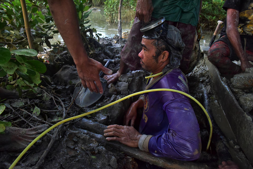 Diver coming up from mud pit