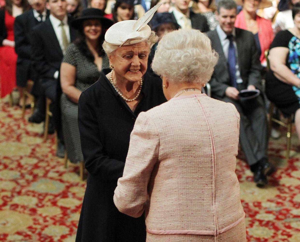 Angela Lansbury is made a Dame Commander by Queen Elizabeth II during an Investiture ceremony at Windsor Castle, Berkshire