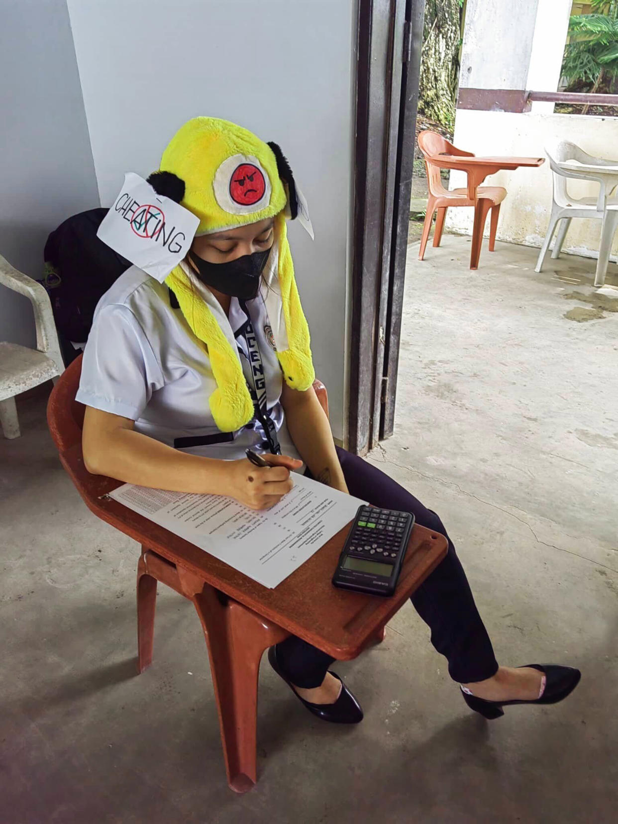 Students at Bicol University College of Engineering in Legazpi City, the Philippines, take an exam on Oct. 17, 2022, while wearing 'anti-cheating hats' they designed as part of an assignment (Mary Joy Mandane-Ortiz)