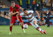 Portugal's Cristiano Ronaldo, right, and Belgium's Toby Alderweireld compete for the ball during the Euro 2020 soccer championship round of 16 match between Belgium and Portugal at La Cartuja stadium, Seville, Spain, Sunday, June 27, 2021. (Lluis Gene/Pool Photo via AP)