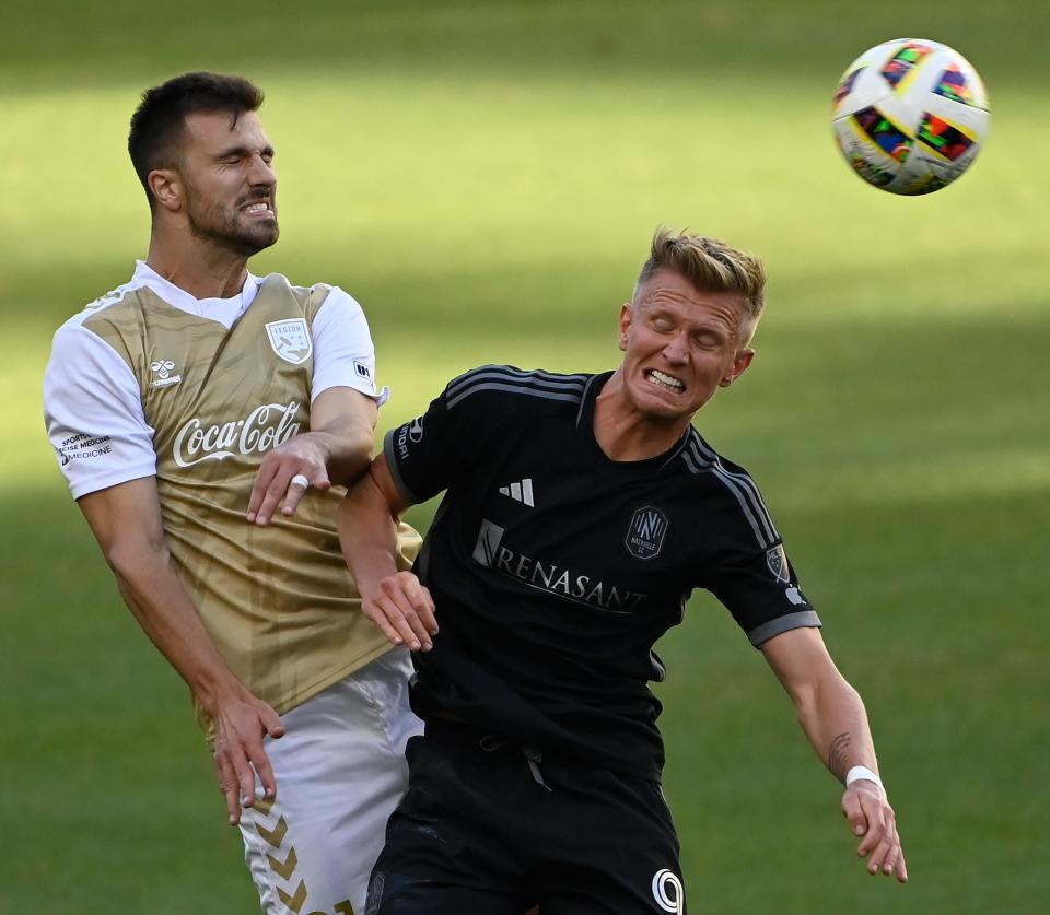 Birmingham Legion FC defender Alex Crognale (21) heads the ball away from Nashville SC forward Sam Surridge (9) during the second half of an MLS preseason soccer match Wednesday, Feb. 7, 2024, in Nashville, Tenn.