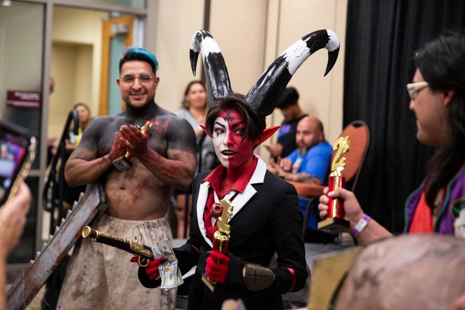 Emma Zavala, middle, reacts after winning first place in the adult costume contest at the Las Cruces Comic Con on Saturday, Aug. 20, 2022, at Las Cruces Convention Center. 