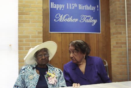 Jeralean Talley (L) sits at the head table with her friend Marian Allen during a celebration of her 115th birthday at the New Jerusalem Missionary Baptist Church in Inkster, Michigan in this file photo taken May 25, 2014. REUTERS/Rebecca Cook