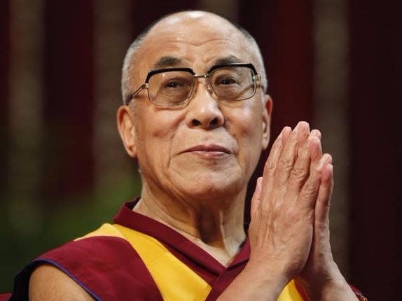 The Dalai Lama gestures before speaking to students during a talk at Mumbai University February 18, 2011. REUTERS/Danish Siddiqui 