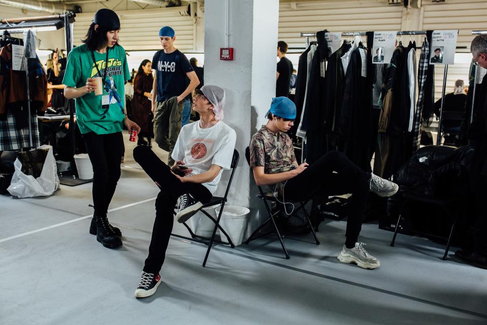 Models keep their hair kempt before the Dries show