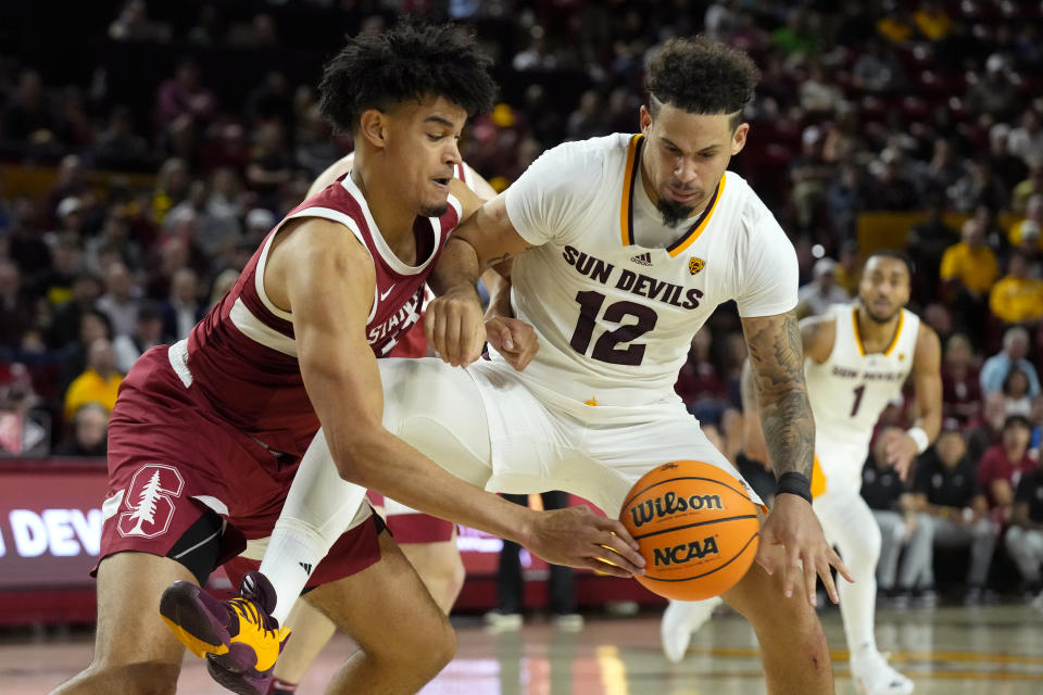 Stanford Cardinal forward Spencer Jones, left, fouls Arizona State guard Jose Perez (12) during the second half of an NCAA college basketball game Thursday, Feb. 1, 2024, in Tempe, Ariz. Stanford won 71-62. (AP Photo/Ross D. Franklin)