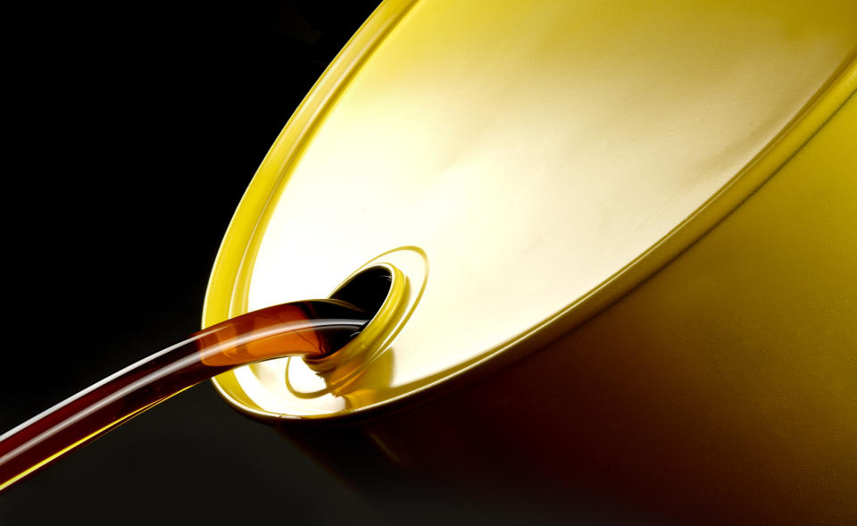 Oil pours from a golden oil drum