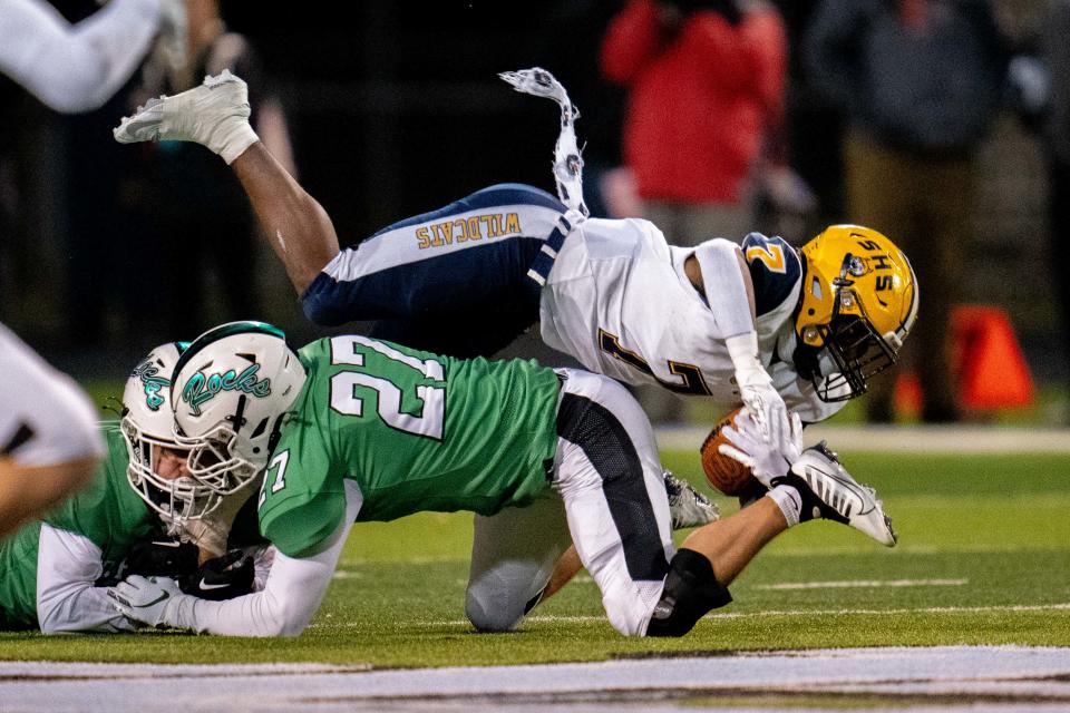 Dublin Coffman's Sammy Moloney (27) tackles Springfield's Bay Bay Norman (7) during Friday night's game.