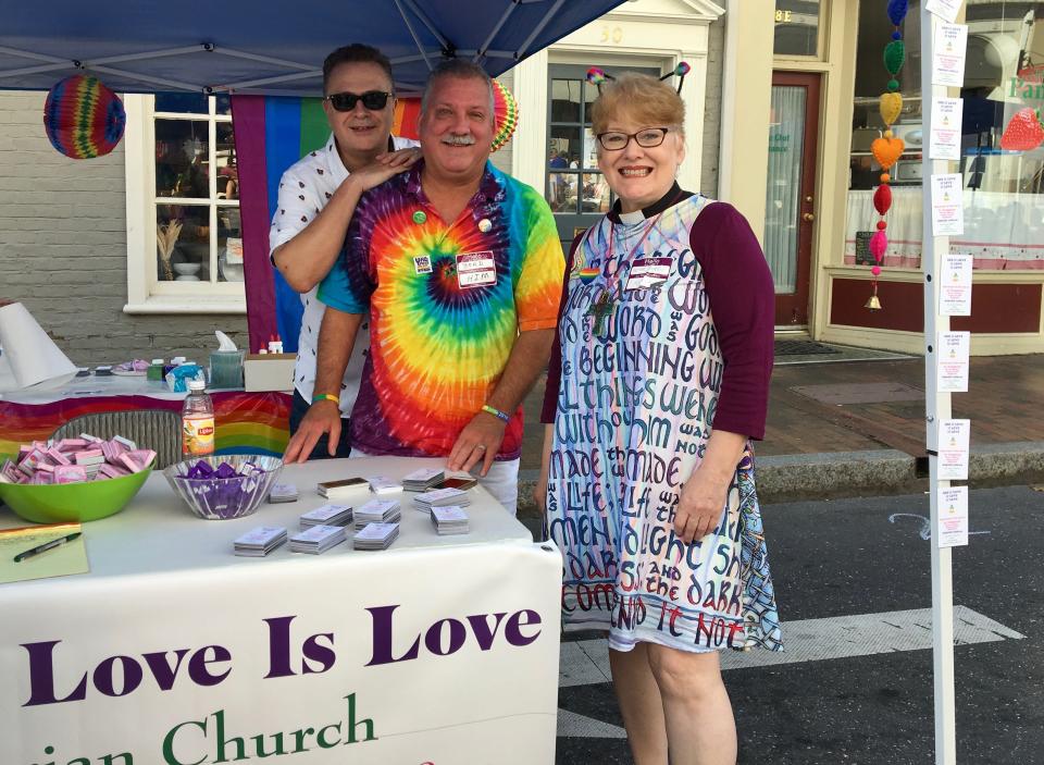 Married at First Presbyterian Church in Staunton, Gary Wilson and Brad Furr stand with their pastor, Rev. Karen Allamon, at Staunton Pride on Saturday, Oct. 6, 2018.
